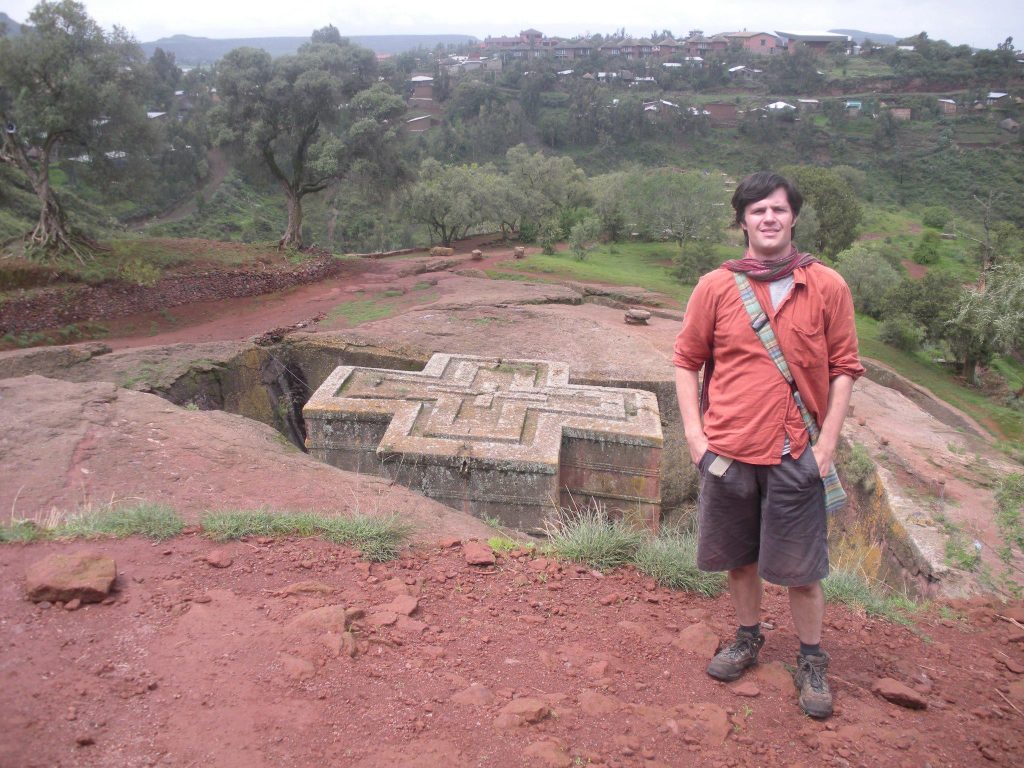 Damian Esteban standing in front of an ancient Christian site.